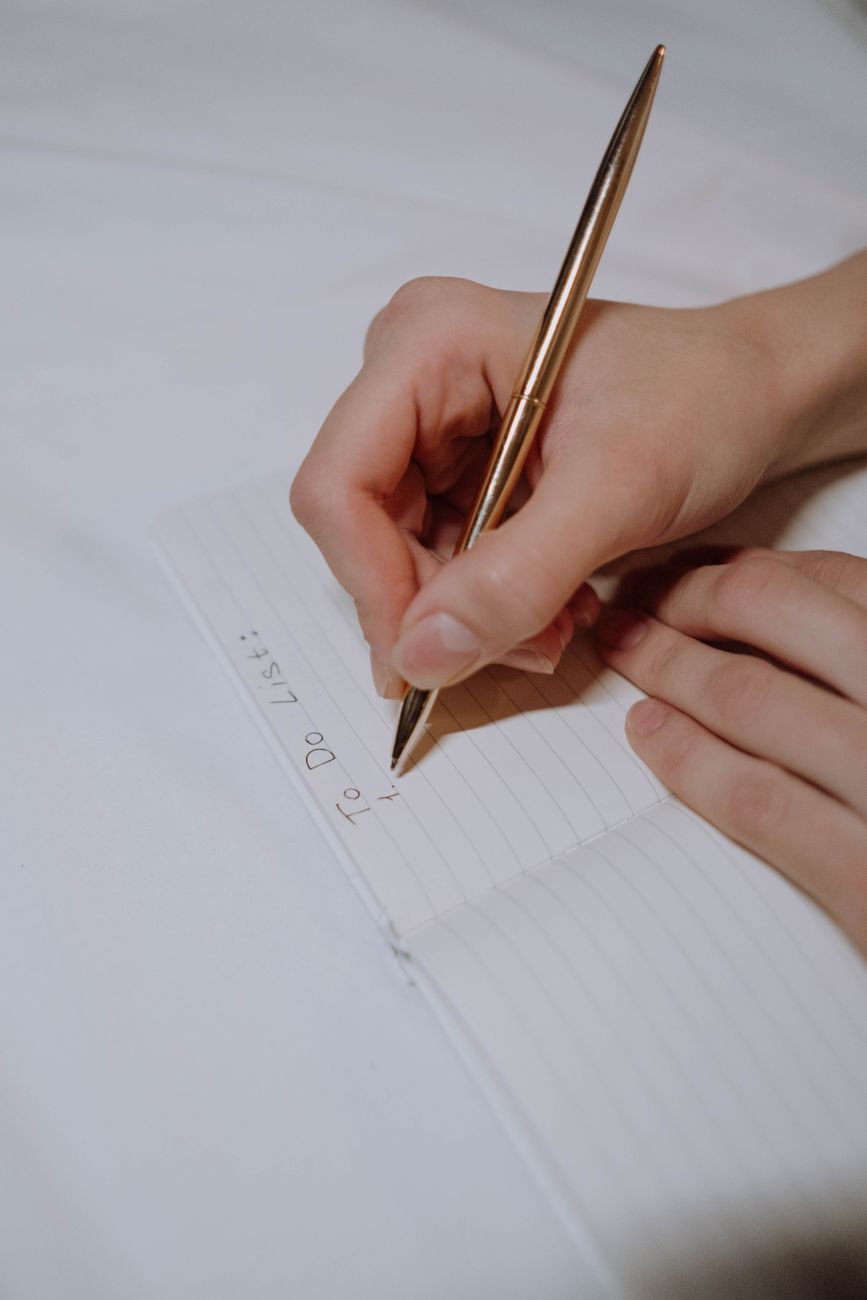 person writing a to do list
