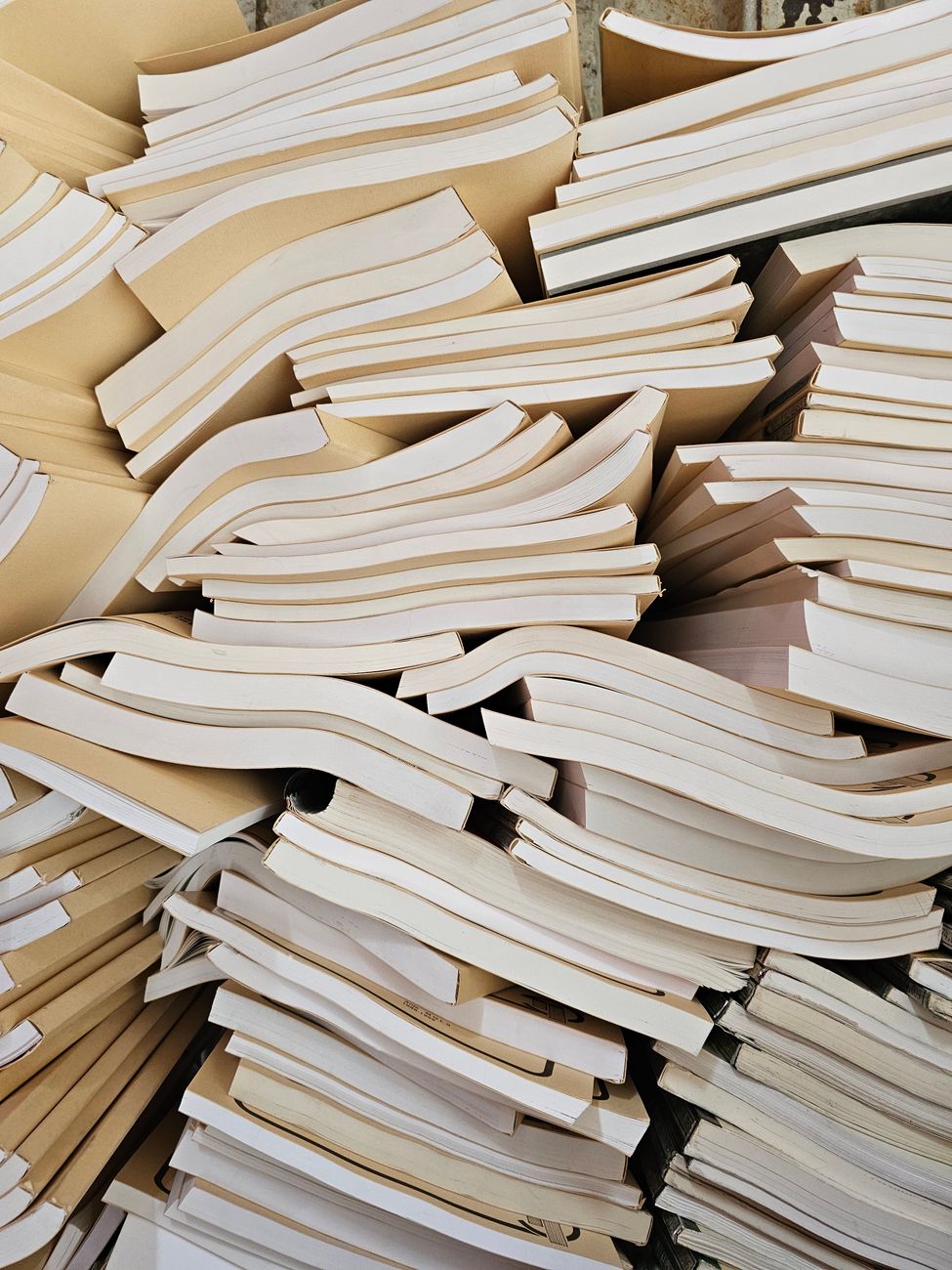 stack of unorganized books with white covers